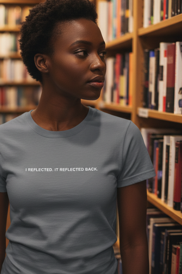 African American woman in bookstore wearing I REFLECTED IT REFLECTED BACK shirt