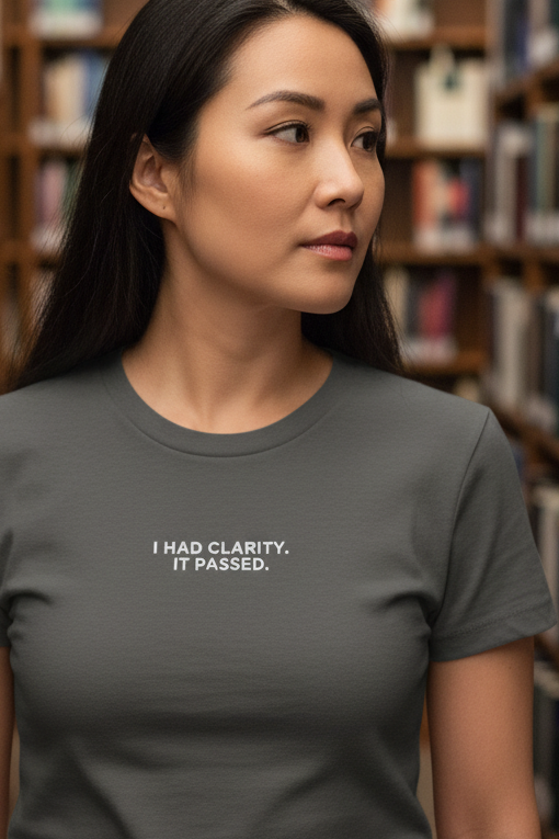 Asian woman in library wearing I HAD CLARITY IT PASSED shirt