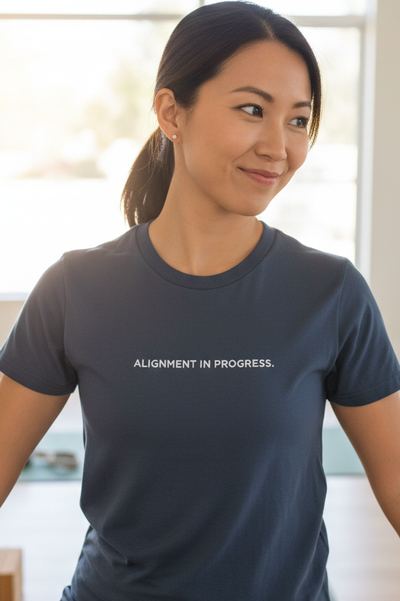 Asian woman wearing ALIGNMENT IN PROGRESS shirt