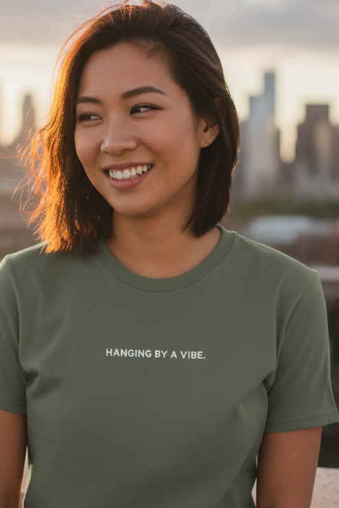 Asian woman wearing HANGING BY A VIBE shirt