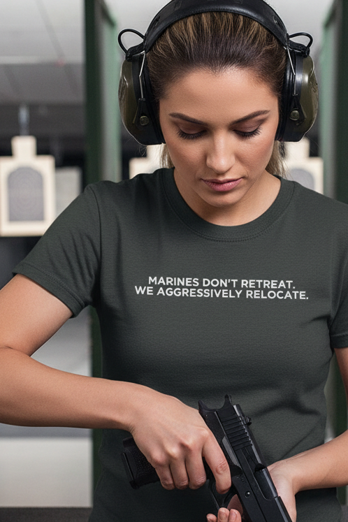 Female model wearing MARINES DON'T RETREAT shirt at shooting range - loading pistol with ear protection