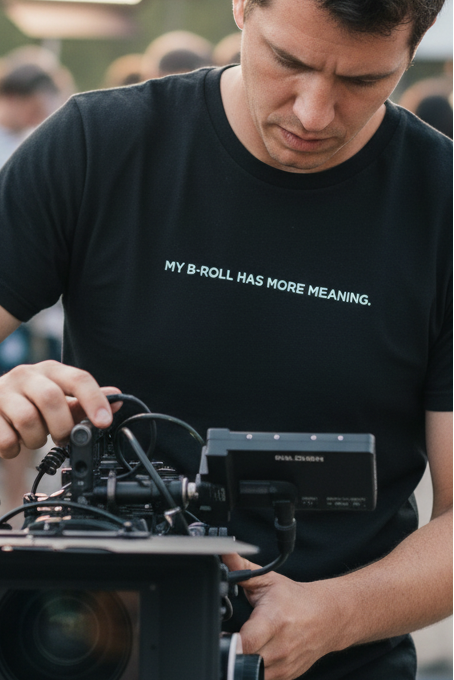 Film crew member wearing MY B-ROLL HAS MORE MEANING shirt - closer framing