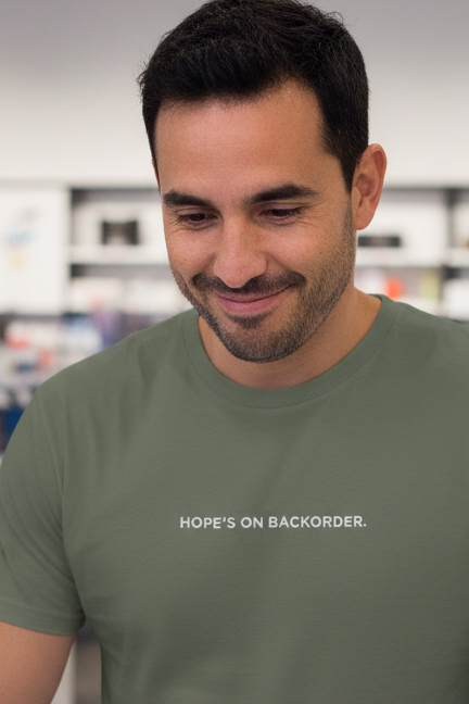 Hispanic man wearing HOPE'S ON BACKORDER shirt