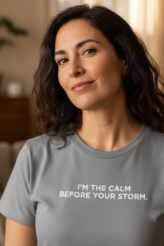 Hispanic woman in her mid-40s wearing I'M THE CALM BEFORE YOUR STORM shirt