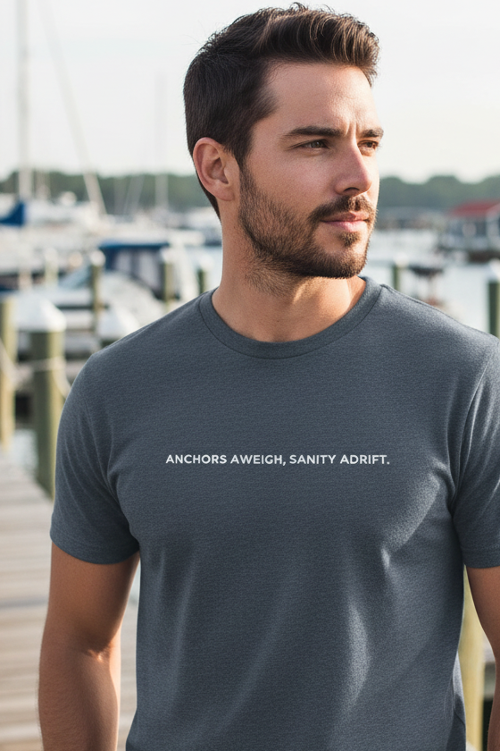 Male model wearing ANCHORS AWEIGH, SANITY ADRIFT shirt in navy at marina - looking away