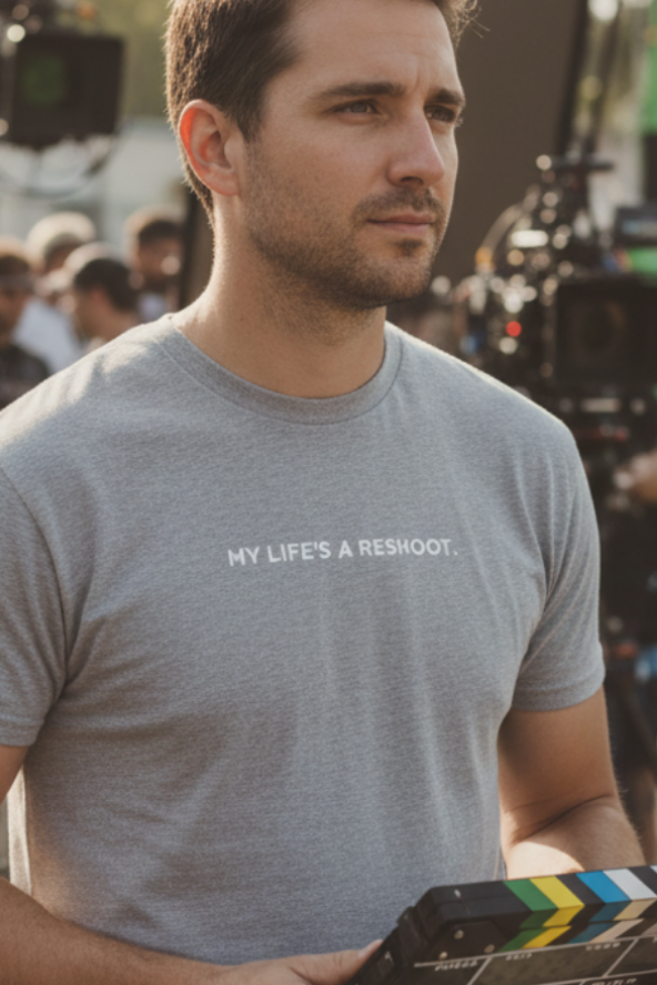 Man on film set with digital slate wearing MY LIFE'S A RESHOOT t-shirt