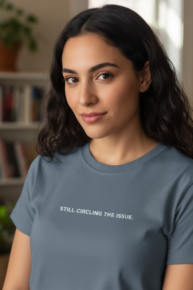 Middle Eastern woman wearing STILL CIRCLING THE ISSUE shirt