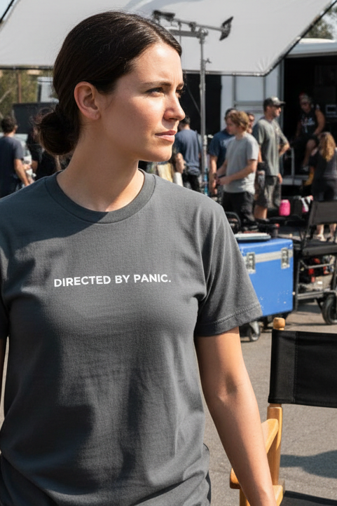 Woman on outdoor film set wearing charcoal DIRECTED BY PANIC shirt
